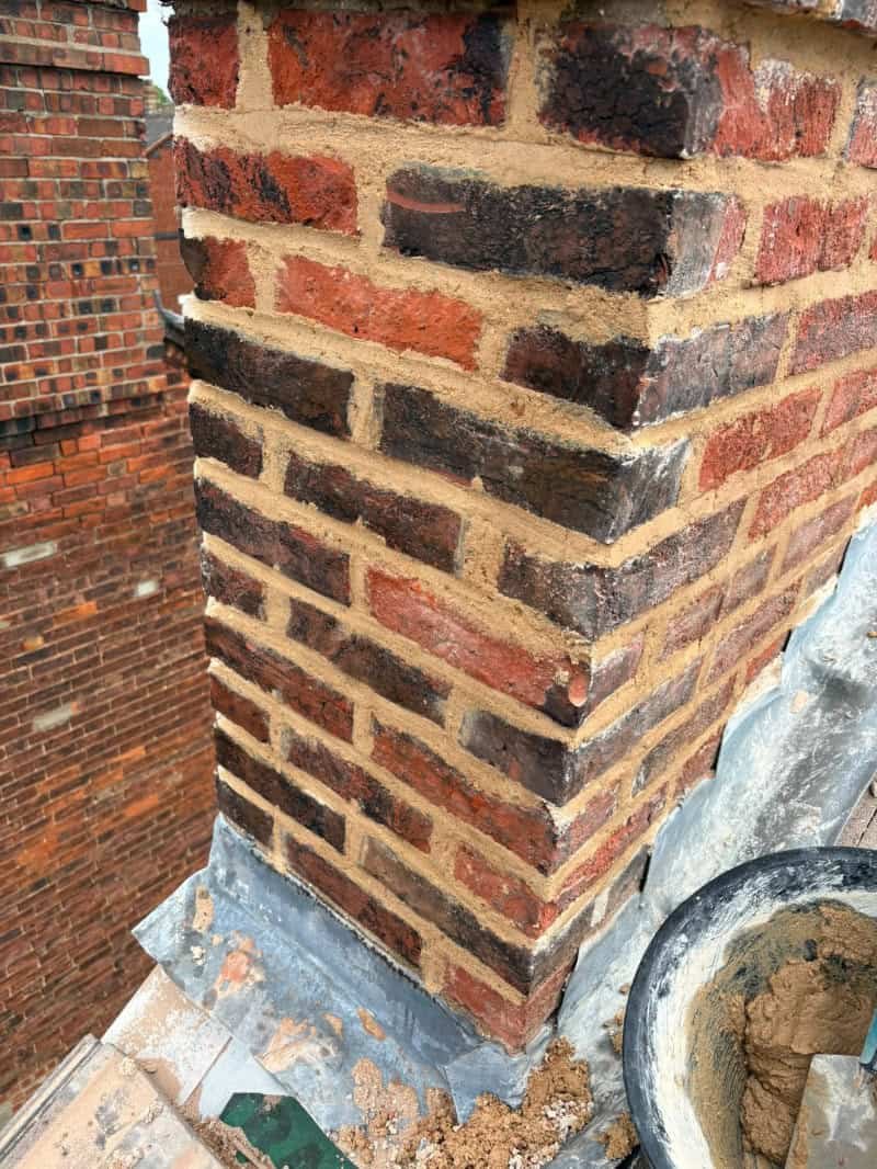 Freshly repointed chimney completed on a Norfolk rooftop