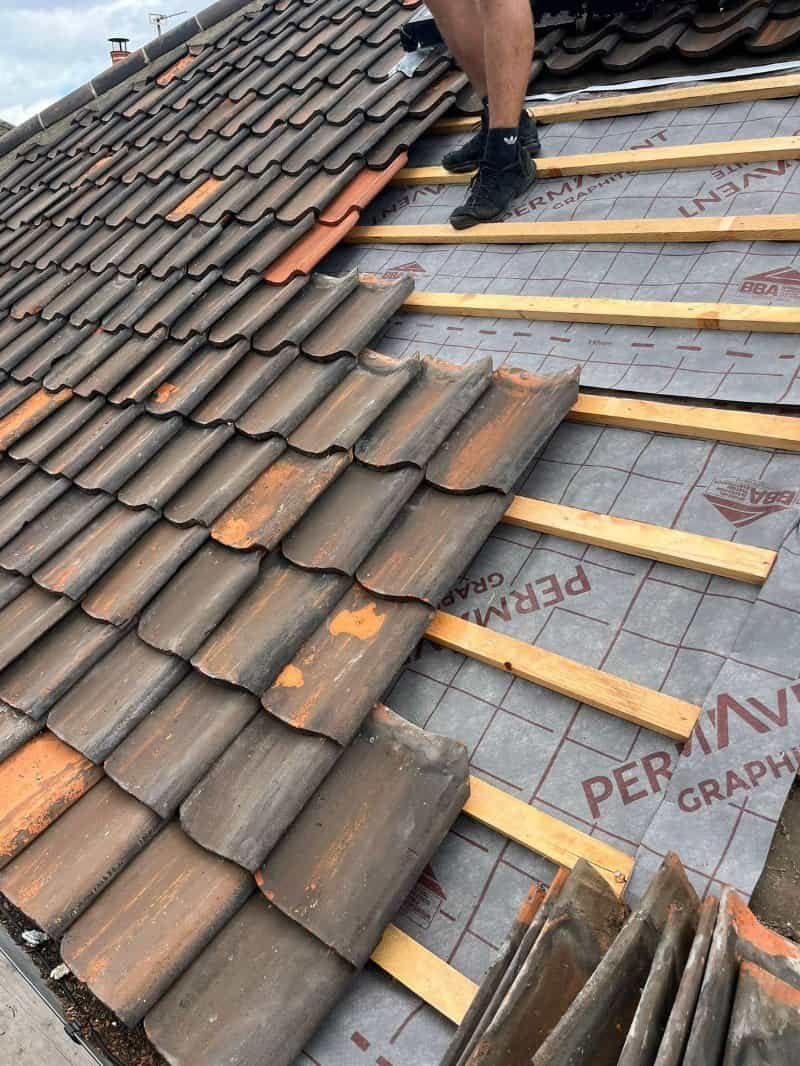 Norwich Roofing Company roofer part way through fitting a new roof in King's Lynn