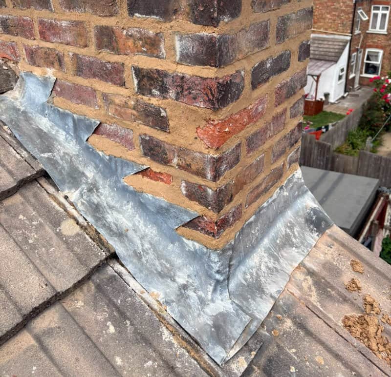 Lead flashing fitted around a chimney on a Norfolk property