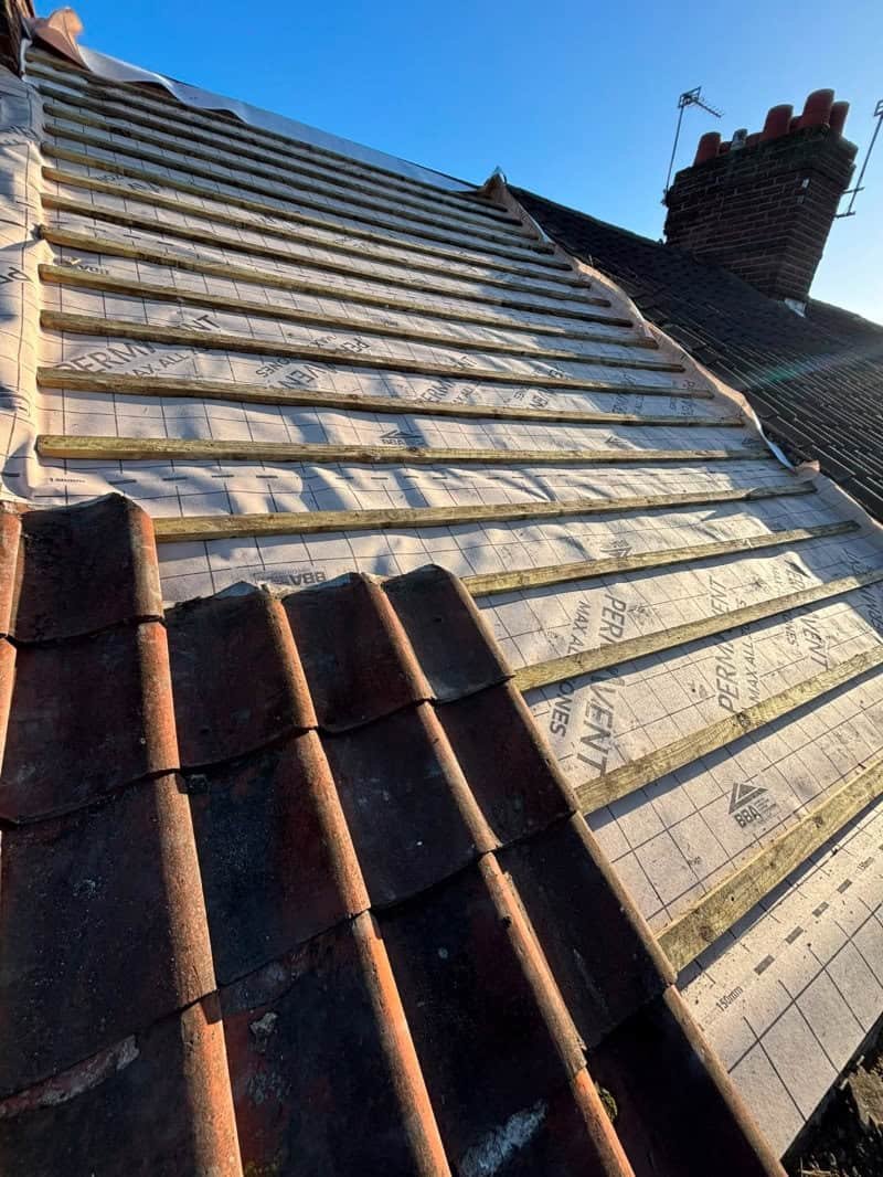 New roof part way through installation in Norfolk with half the tiles fitted