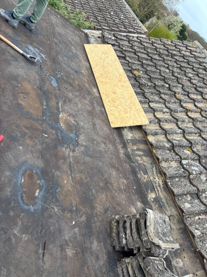 Roofer carrying out a roof repair on a property in Norfolk